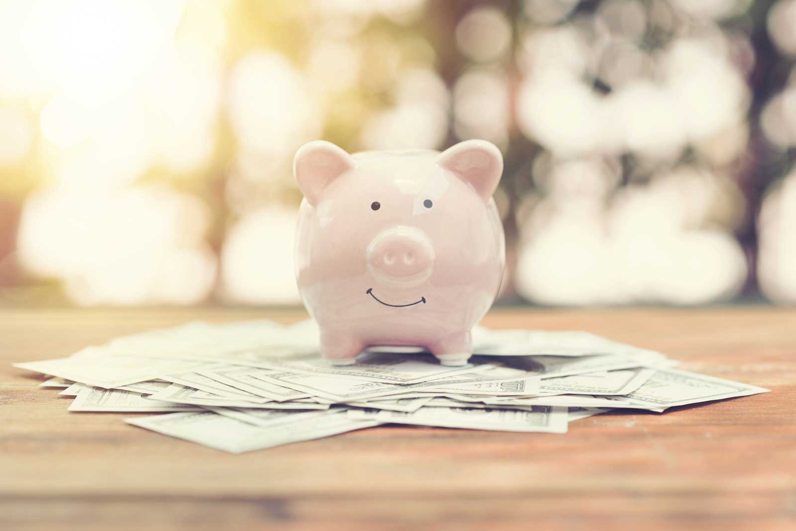 Piggy bank on table at sunset